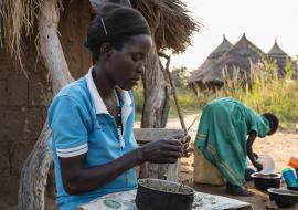 Asio Sarah, the aunt of Akwii's, cooking meal in her home in Kapelebyong 