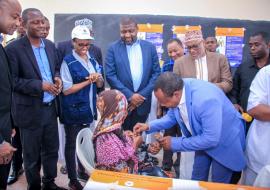 Honorable Othman Masoud, the First Vice President of Zanzibar, giving polio vaccine drops