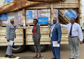 Hon. Dr. Jane Ruth Aceng Acero poses for a photo with Dr. Charles Njuguna (second from right), the WHO Uganda Incident Manager/Emergency Preparedness and Response (EPR) Cluster Lead during the hand-over ceremony of in-kind contributions of medical supplies worth USD 1,123,672 to address the health impact of the drought and food insecurity affecting 19 districts of Karamoja, Lango, and Teso regions in Uganda.