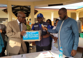 WHO Representative (left) making the symbolic handing over of the consignment to the Minister of Health and Sanitation