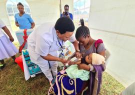 A child receiving routine vaccination during the event 