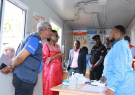 Uganda Health minister Dr. Jane Ruth Aceng (in Red) and WHO Representatitive (First left) Dr. Yonas Tegegn Woldemariam interact with Ministry of Health staff at the screening booth in Mutukula