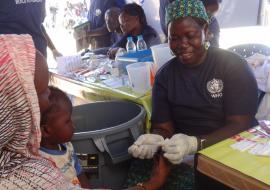 A woman is tested for malaria as part of activities to mark the UN Day