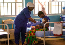  A nurse dressing the sore on the face of a patient suffering from Noma (photo credit Ogbeide