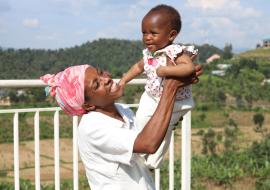 Umutoniwase Marie-Claire playing with her daughter Ornella