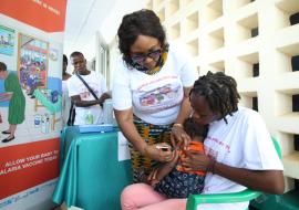 Health Minister Dr. Louise Kpoto administers the first dose Malaria Vaccine during the launch of Malaria Vaccine in Liberia