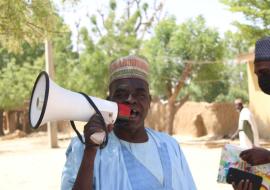 a town crier, Mr Usman calling on parent to get their children to the vaccination post to recieve the MenFive vaccine Photo credit – Ayodamola Owoseye a town crier, Mr Usman calling on parent to get their children to the vaccination post to recieve the MenFive vaccine Photo credit – Ayodamola Owoseye