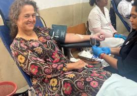 Dr Anne Ancia, the WHO Representative donating blood and calling upon students to commit as lifetime donor
