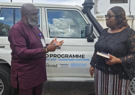 WHO Representative Dr Olu Olushayo handing over the vehicle to Dr Catherine Cooper, Chief Medical Officer at Ministry of Health