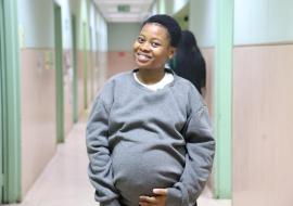 Lesego pose to the camera in the hallway of FF Rebeiro Clinic after her antenatal care.