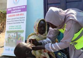 Healthcare worker administering oral cholera vaccine in Renk, South Sudan.