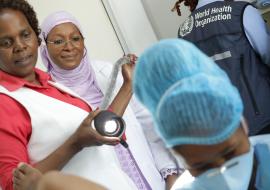 Dr Dille from WHO AFRO  looks on as the team conducts leep on a patient.
