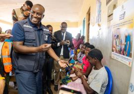 WHO Malawi Rep Dr Charles Njuguna vaccinates a child against polio at Kabudula Community Hospital