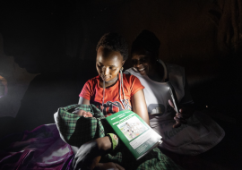 Neshoo Leaungokiok and her newborn baby, sits with Lucy Makena, a reproductive health officer from a nearby mobile outreach clinic supported by WHO. 