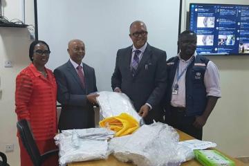 WHO country Representative Dr Wondimagegnehu Alemu hands over personal protective equipment to Chief Executive Officer of the Nigeria Centre for Disease Control Dr Chikwe Ihekweazu