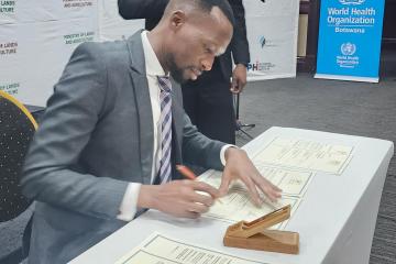 Honorable Acting Minister of Health, Mr Lawrence Ookeditse, signing the commitment for the implementation of the One Health National Strategy