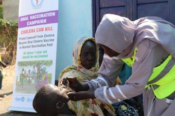 Healthcare worker administering oral cholera vaccine in Renk, South Sudan.