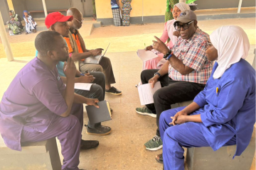 WHO, UNICEF and UNFPA programme officers in discussion with frontline health workers at a Brikamaba health Centre, to explore how to strengthen and improve service delivery