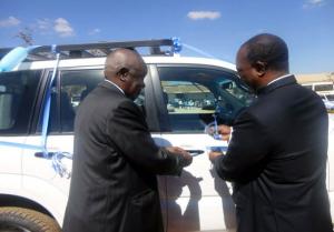 The WHO Representative, Dr. Olusegun Babaniyi right handing over the Toyota Landcruiser Prado to the Vice Chancellor at LAMU, Professor Lupando Munkonge