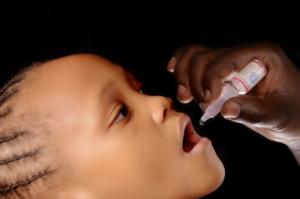Eligible child receiving oral polio vaccine in Abuja