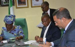 The Minister (left), AfDB Country Director and WR signing the MOU