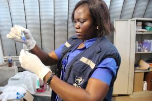 WHO South Sudan Laboratory Scientist, Jane Pita, conducts a rapid test on a specimen during a cholera investigation