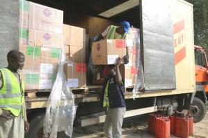 A team of casual workers offloading emergency medical supplies at State Ministry of Health warehouse