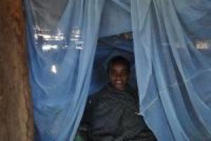 Boy sits under insecticide-treated bed net in Wonchit kebele, Dera Woreda, Amhara Region, Ethiopia.