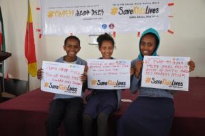 Children calling for action via the #SaveKidsLives signboard