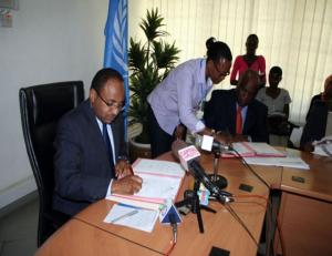 The WHO Representative, Dr. Rufaro Chatora and the Minister for Health and Social Welfare, Hon.Dr Hussein Ali Mwinyi signing certificates of transfer