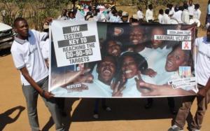 The marchers displaying their banners showing the national VCT Day 2016 campaign theme in Mumbwa district