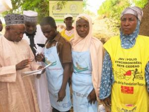 The Zamfara state Commissioner for Health checking a tally sheet at border post