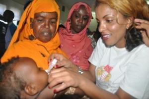 Polio Goodwill Ambassador, e polio goodwill ambassador, Nimco Dareen, administering the two drops.