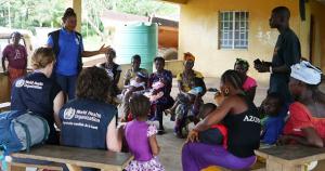 Ebola outbreak in Sierra Leone: WHO staff talking to mothers in Sierra Leone on getting children to health care.