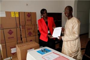 Dr Mitula (left) formally making the donation and handing over to Dr Fofanah