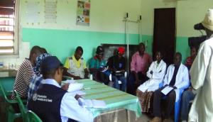 WHO and Ministry of Health staff discussing with nurses