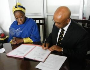 Hon Minister (left) and the WHO Representative signing document