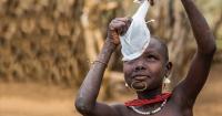 A South Sudanese boy examins a cloth filter The Carter Center