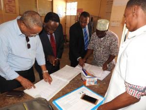 Dr Kamwa reviewing Chumbuni CTC patient records with the CTC staff