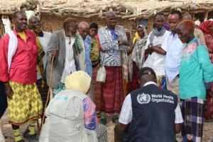 The Risk Communication Team in a discussion with a group of men in the affected community