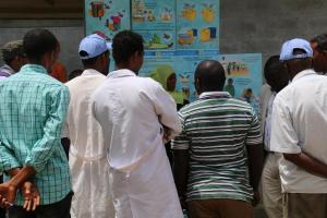 A WHO/UNICEF Risk Communication team member explains AWD prevention and control to health workers and residents of Gabo Gabo Kabele using pictorial posters (Photo: Ms Tseday Zerayaco)