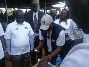 Dr Riek Gai Kok, the Honorable Minister of Health is ready to take Ivermectin tablets administered by WHO NTD Program manager at the Freedom Square Ground in Tonj State. Photo WHO.