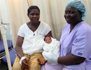 Midwife holding newborn after delivery