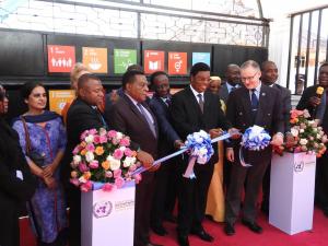 Hon. Kassim M. Maliwa (MP), the Prime Minister of the United Republic of Tanzania cutting the ribbon to mark the launch of the new UN Dodoma Office. To his right is the WHO Representative, Dr. Matthieu Kamwa, Hon. Amb. Dr. Augustine Mahiga (MP), Minister for Foreign Affairs and East African Cooperation, to his left is Mr. Alvaro Rodriguez, the UN Resident Coordinator holding the ribbon. Standing to the far left and right are government officials and Heads of UN Agencies.