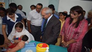 The first Mauritian baby receiving the Hexavalent vaccine in the presence of Dr A. Husnoo, Health Minister, Mrs R. Jadoo-Jaunbocus, Minister of Gender Equality, Child Development and Family Welfare and other eminent staff of the Ministry of Health and Quality of Life