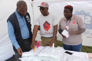 Dr. Lastone Chitembo, HIV/AIDS/TB Advisor at WHO visiting the Society for Family Health exhibition stand where HIV self testing was promoted.