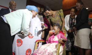 Minister for Health, Hon. Ummy Mwalimu, witnessing a child taking the new child-friendly TB medicine