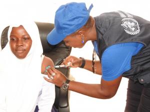WHO staff vaccinating a girl during the occasion.