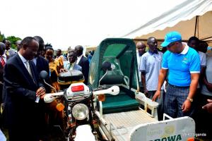 Dr Henry Mwebesa (left) and Dr Yonas (right in blue shirt) view a an ambulance that is used locally to transport patients to health centers in Luweero district