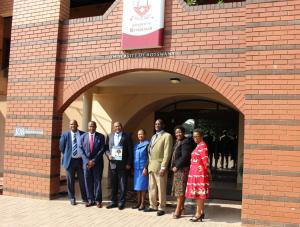 The WHO and the UB Teams after the ceremony, with the Vice Chancellor holding a document